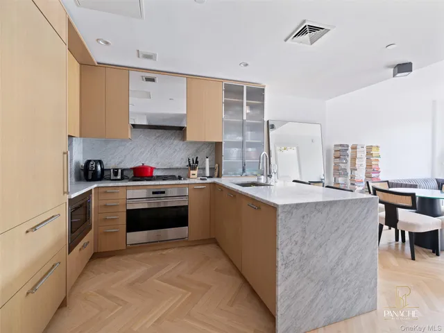a kitchen with kitchen island granite countertop a sink counter top space and cabinets