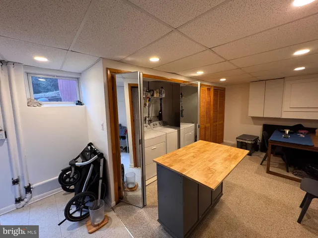 a room with gym equipment and kitchen view