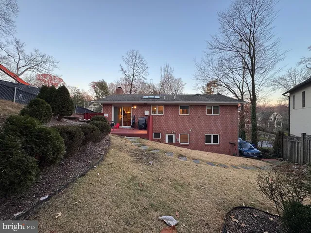 a view of a house with a yard covered with snow in a yard