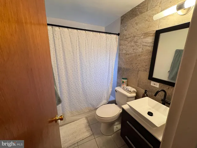 a bathroom with a toilet a sink and a mirror