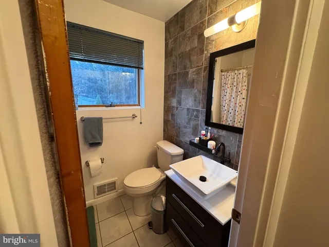 a white toilet sitting next to a bathroom sink