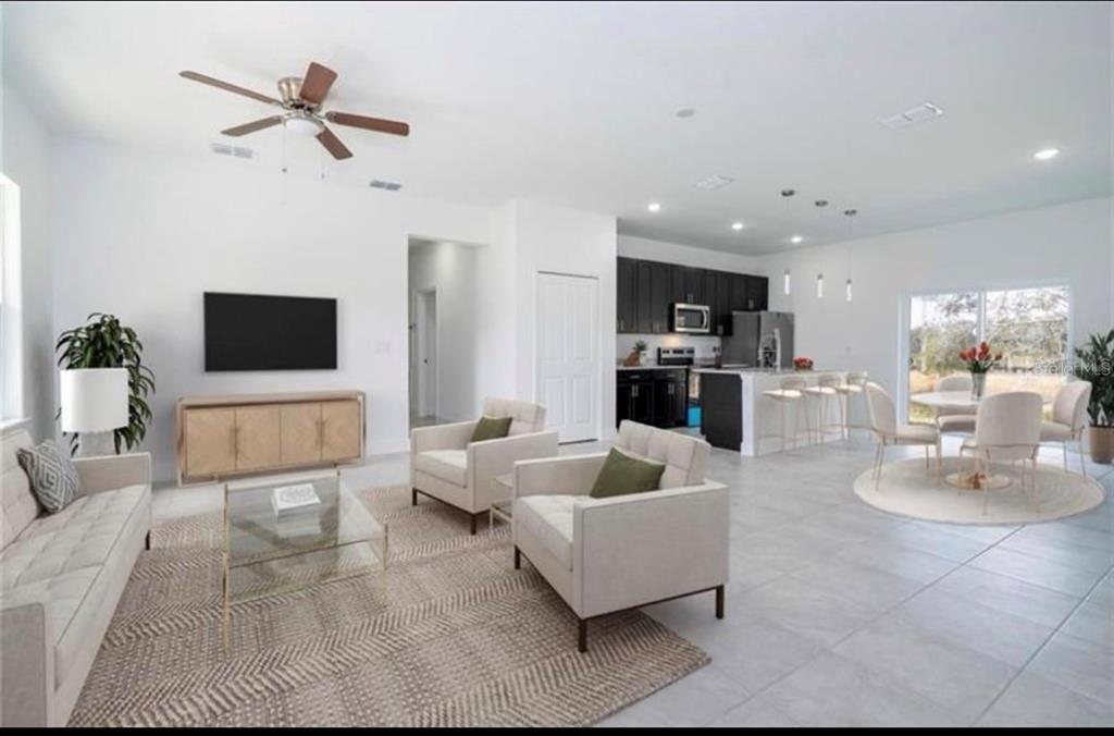 9809 North Swanee Terrace Dunnellon, FL 34433 - Photo 4 of 24 a living room with furniture and a flat screen tv