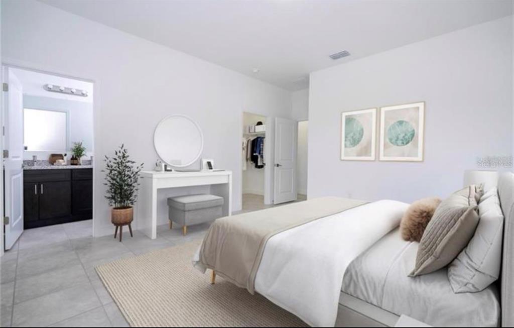 9809 North Swanee Terrace Dunnellon, FL 34433 - Photo 6 of 24 a bedroom with a bed and a chandelier