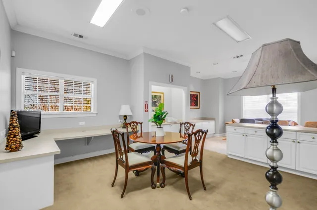 a living room with furniture and kitchen view
