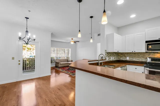 a living room with hard wood flooring and a couch