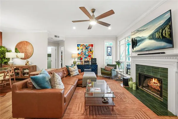 a living room with furniture a flat screen tv and a fireplace