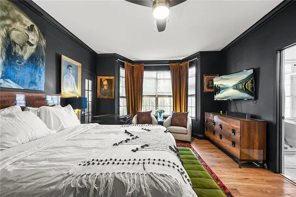 a bedroom with a bed couch and a window