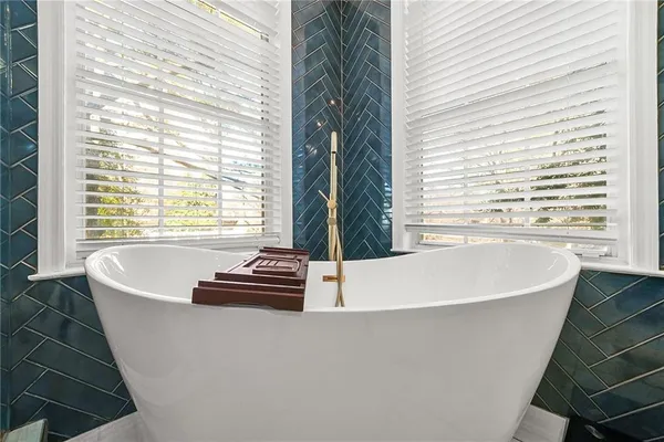 a spacious bathroom with a double vanity sink a large mirror and a shower