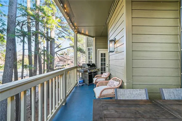 a view of a balcony with table and chairs
