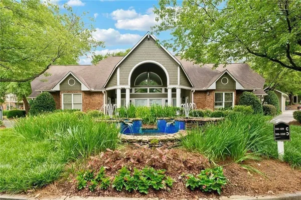 an aerial view of a house with swimming pool and furniture