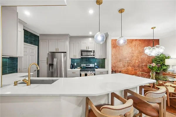 a dining room with furniture and a chandelier