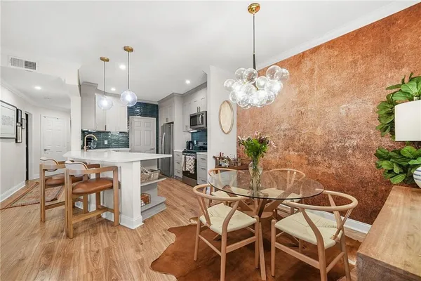a kitchen with stainless steel appliances granite countertop a stove and cabinets