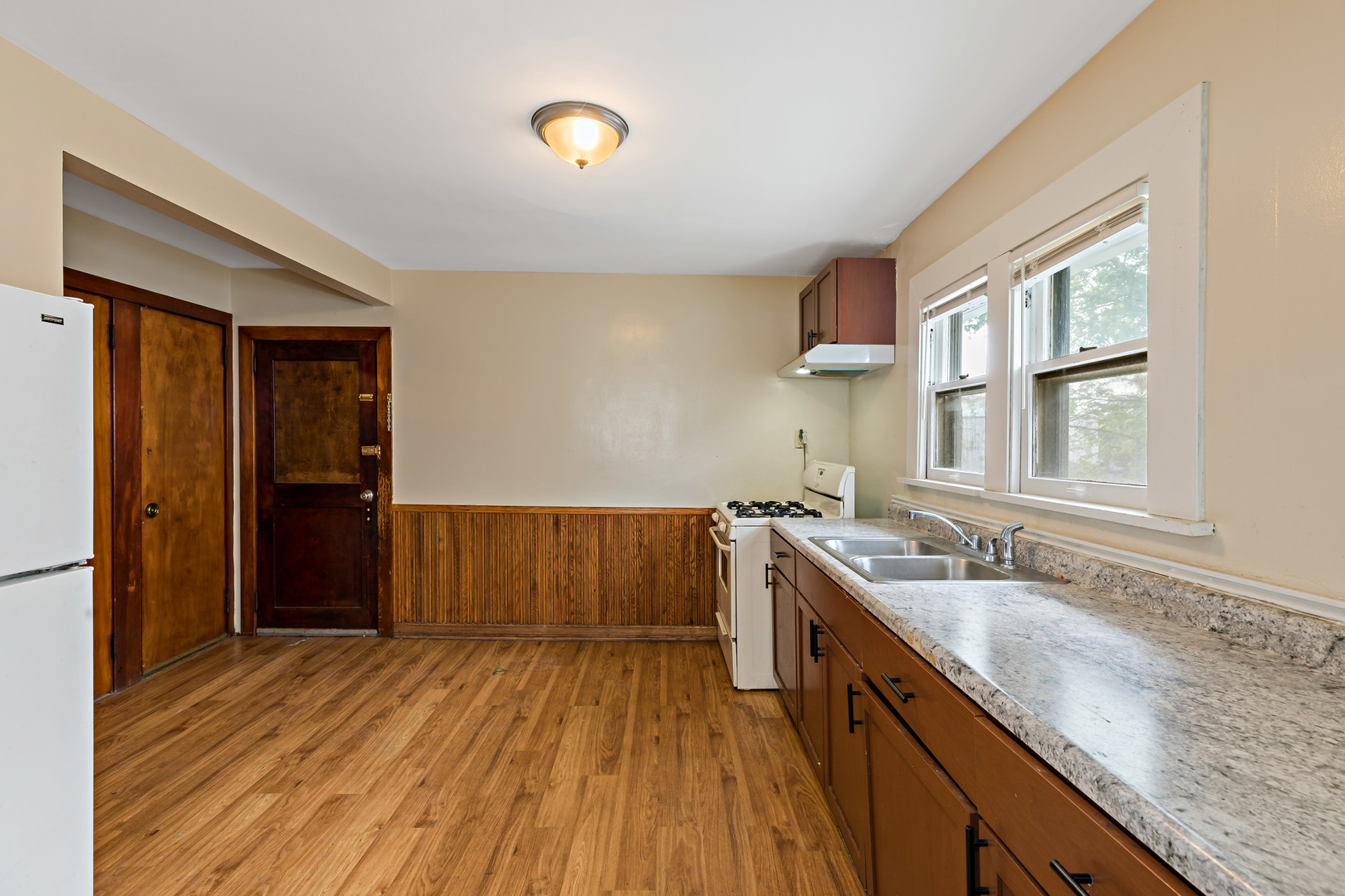 3441 Chicago Road Steger, IL 60475 - Photo 9 of 28 a kitchen with a sink and wooden floor
