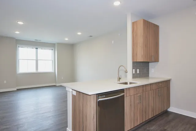 a kitchen with a sink cabinets and wooden floor