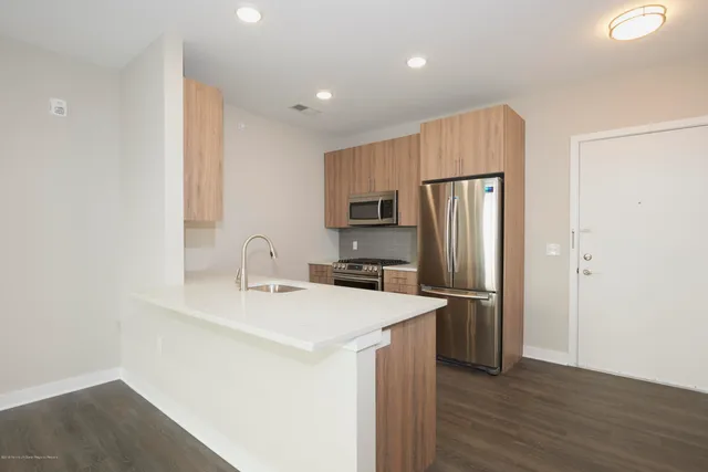 a kitchen with stainless steel appliances a refrigerator and a sink