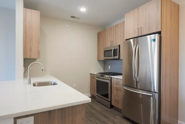 a kitchen with appliances a sink and a refrigerator