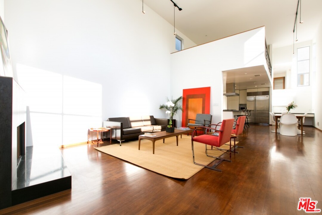 216 Grand Boulevard Venice, CA 90291 - Photo 2 of 28 a living room with fireplace furniture and a large window