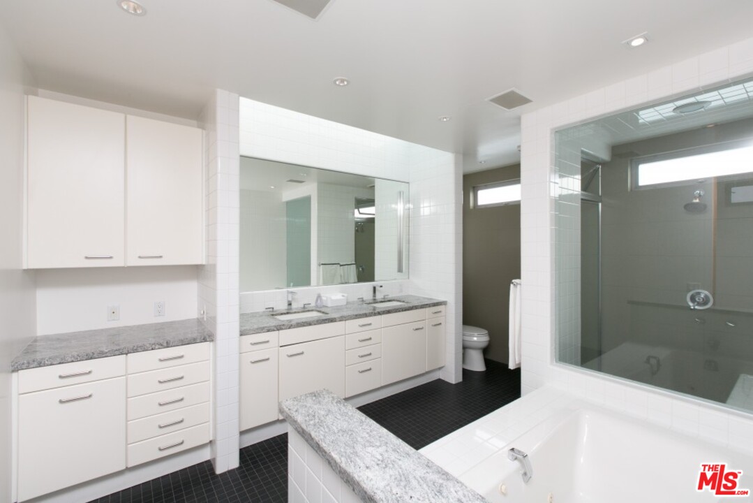 216 Grand Boulevard Venice, CA 90291 - Photo 11 of 28 a bathroom with a granite countertop sink mirror and double