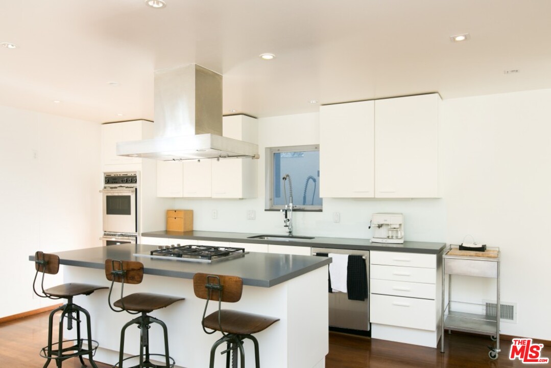 216 Grand Boulevard Venice, CA 90291 - Photo 6 of 28 a kitchen with stainless steel appliances kitchen island granite countertop a sink and cabinets