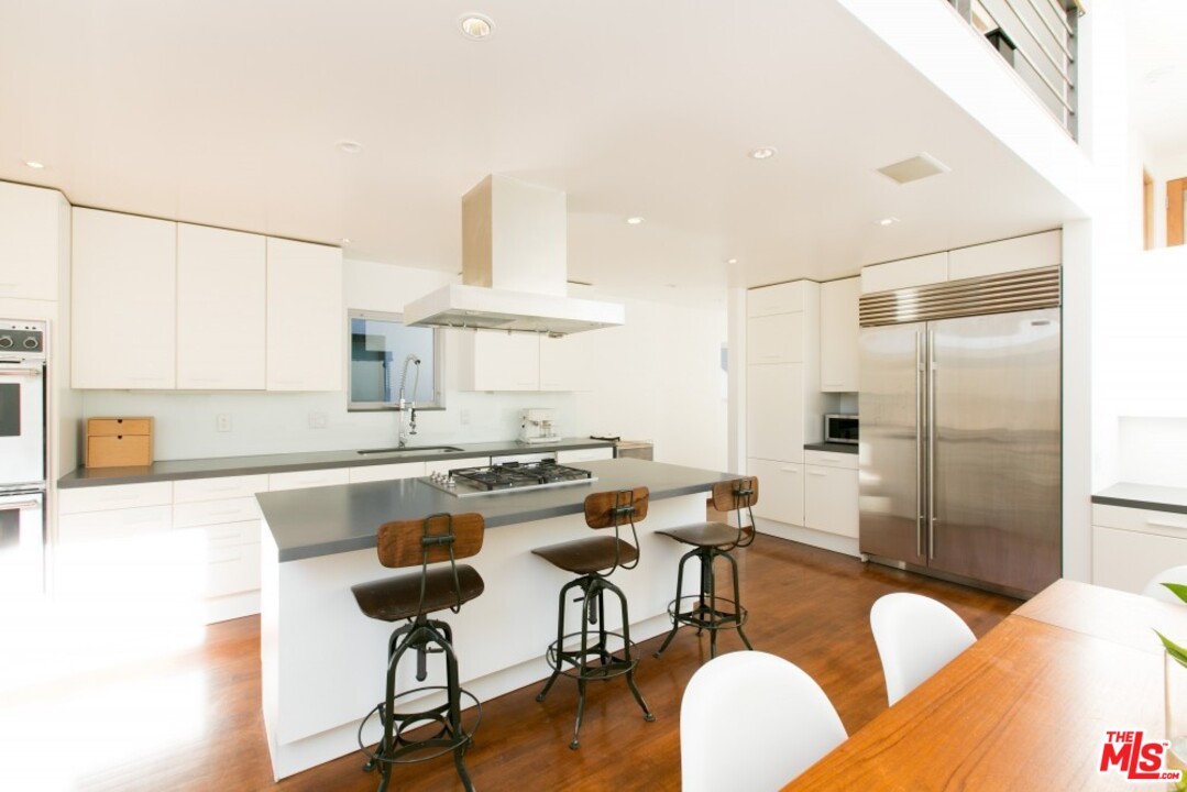216 Grand Boulevard Venice, CA 90291 - Photo 7 of 28 a kitchen with stainless steel appliances granite countertop a refrigerator and a stove top oven
