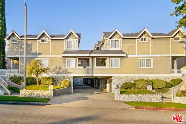 a view of a brick house with large windows