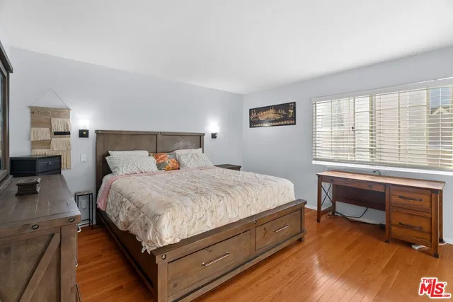 a bed room with a bed and a chair