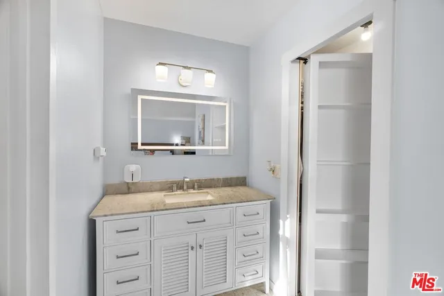 a bathroom with a granite countertop sink a mirror and a