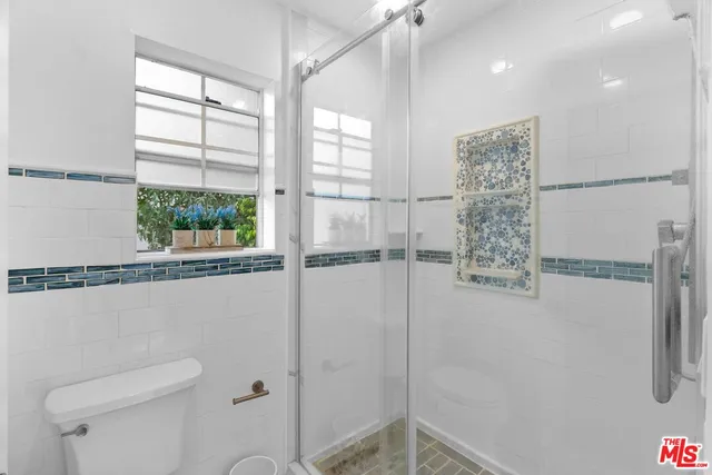 a bathroom with a shower and a toilet