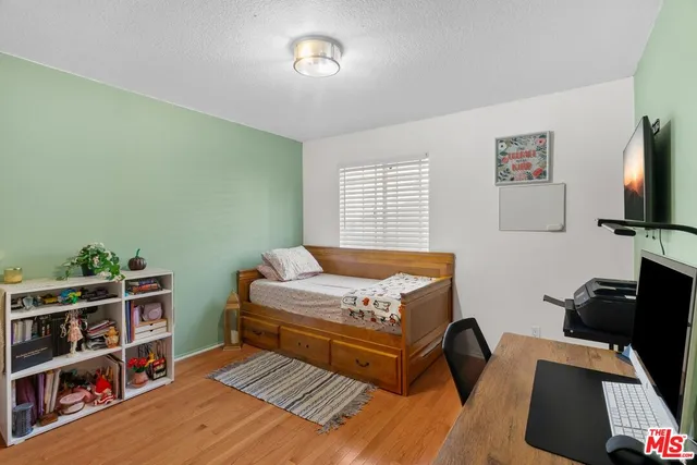 a bedroom with furniture and a book shelf