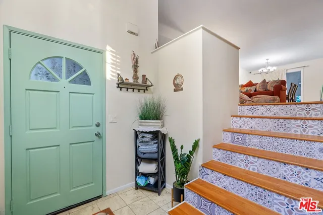 a view of a bedroom with baby crib and cabinet