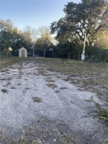 a view of a outdoor space with deck and tree