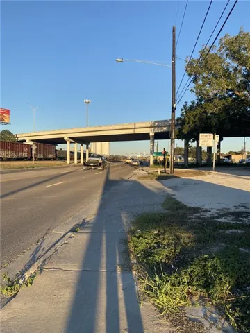 a view of a street with cars parked