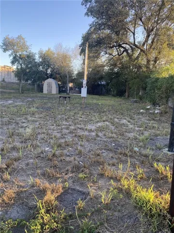 a backyard of a house with table and chairs