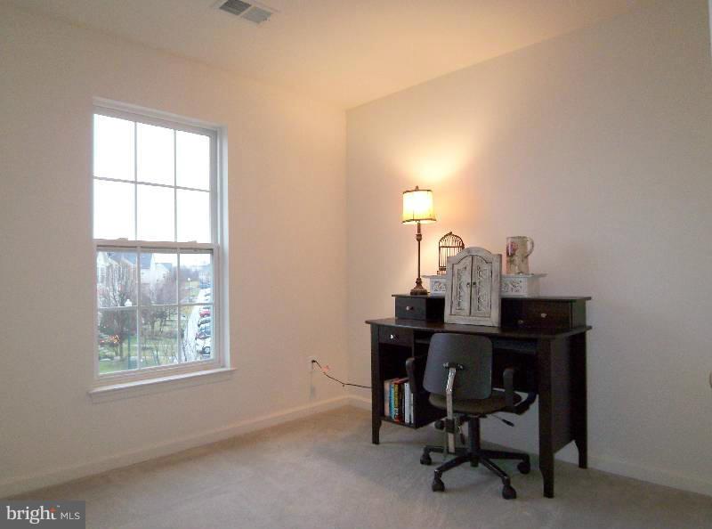 179 Riparian Lane Ranson, WV 25438 - Photo 8 of 30 a view of a workspace with furniture and a window