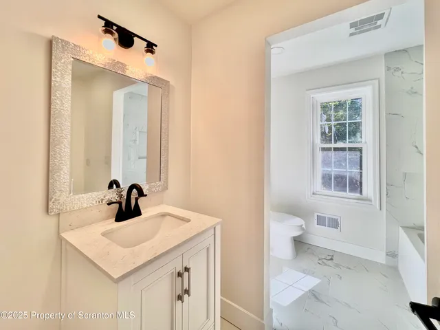 a bathroom with a sink and a toilet