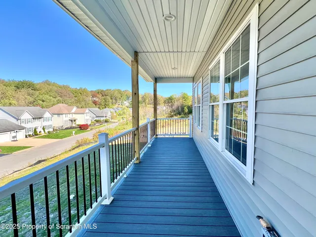 a view of a balcony with wooden floor
