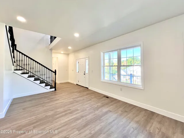 a view of an entryway with wooden floor