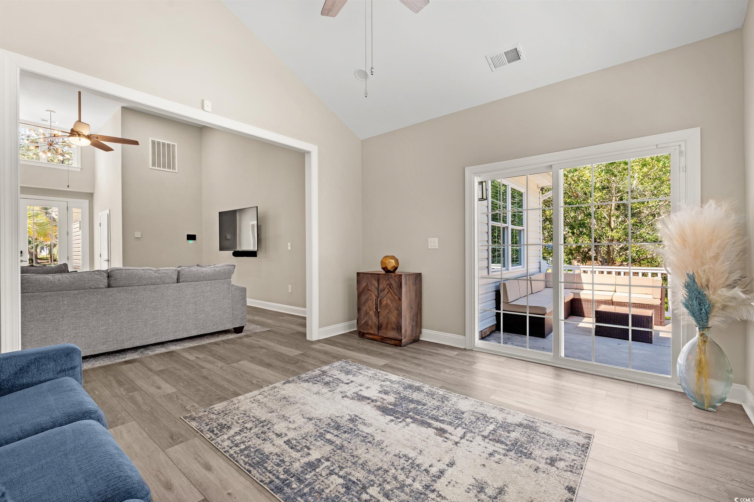 714 Charlotte Road Myrtle Beach, SC 29577 - Photo 12 of 30 Living room featuring ceiling fan, high vaulted ceiling, light wood-style flooring, and healthy amount of natural light
