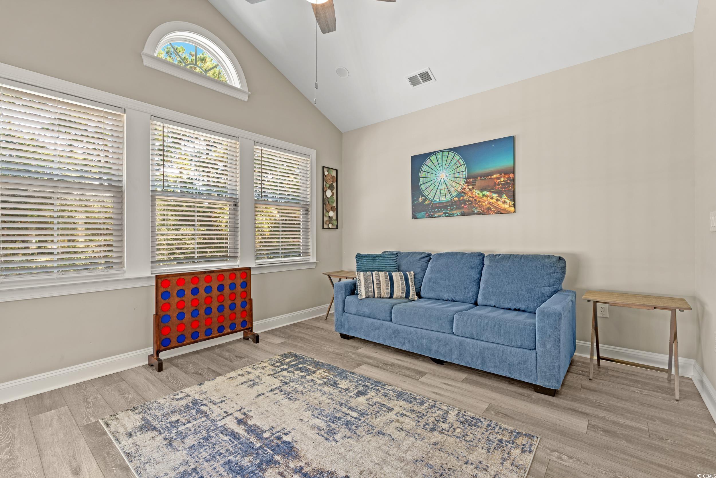 714 Charlotte Road Myrtle Beach, SC 29577 - Photo 13 of 30 Living area with high vaulted ceiling, ceiling fan, and light wood-type flooring