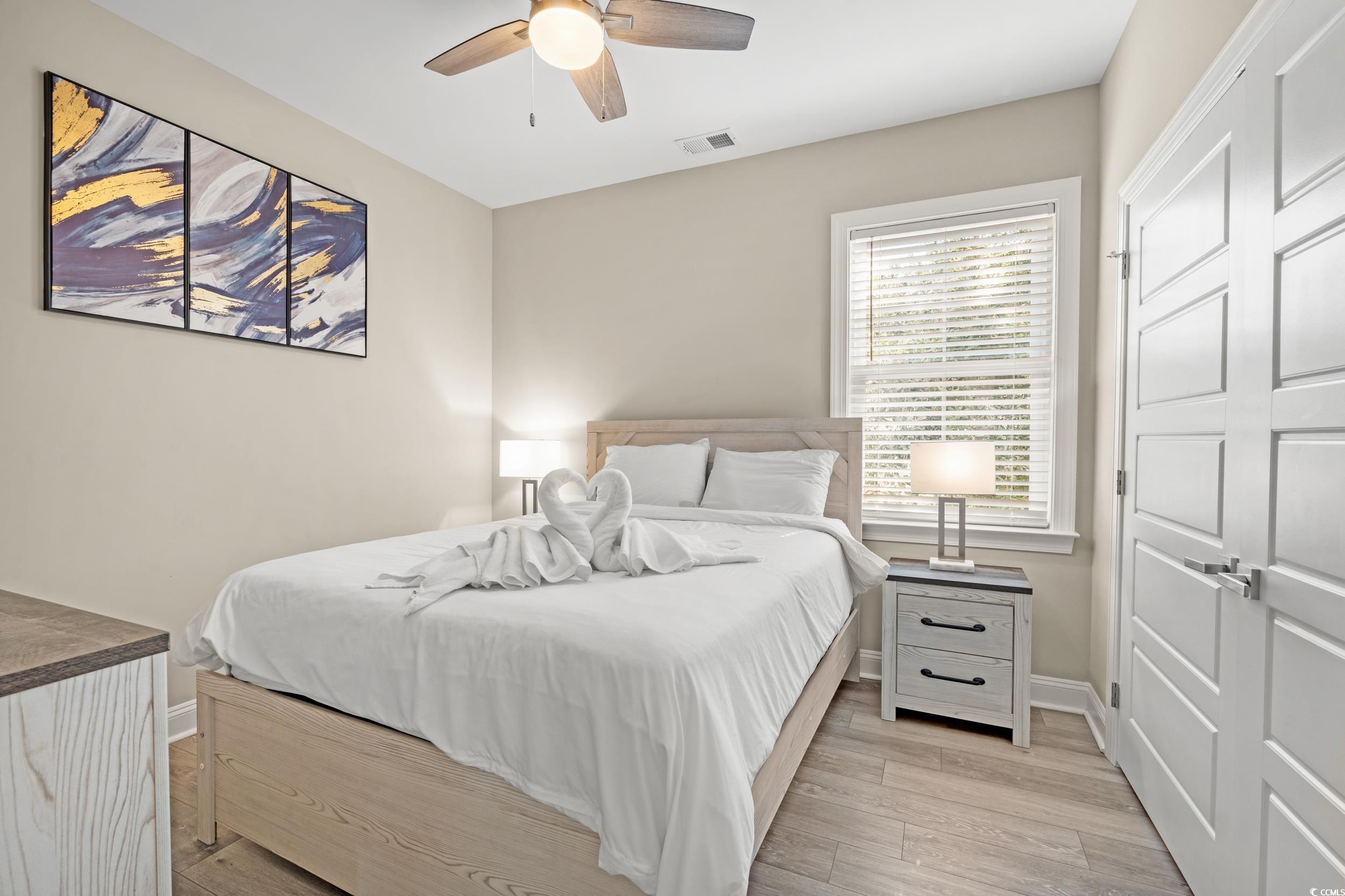 714 Charlotte Road Myrtle Beach, SC 29577 - Photo 19 of 30 Bedroom with light wood-style floors and ceiling fan