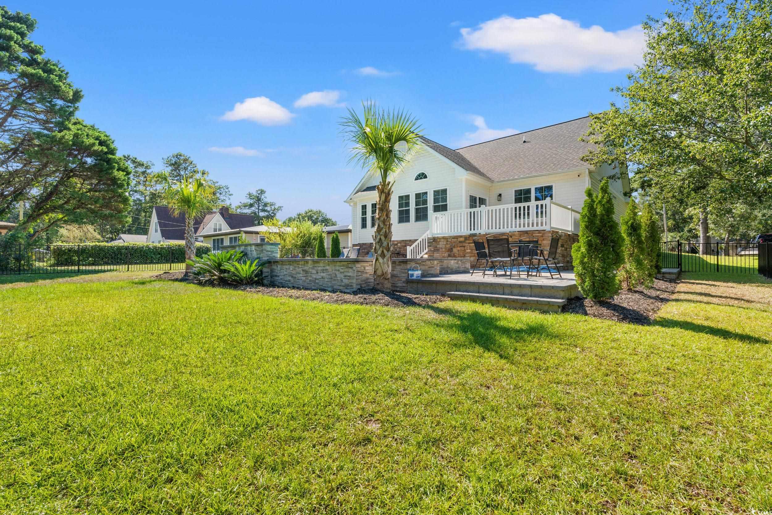 714 Charlotte Road Myrtle Beach, SC 29577 - Photo 28 of 30 Rear view of property with a wooden deck and stone siding