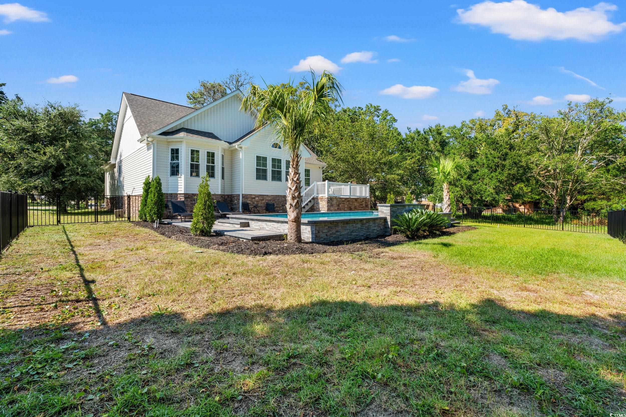 714 Charlotte Road Myrtle Beach, SC 29577 - Photo 29 of 30 Rear view of property with a fenced backyard and a patio area