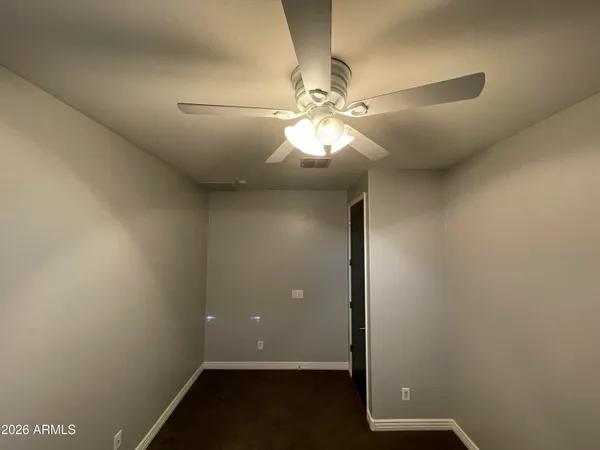 a view of a room with wooden floor chandeliers and kitchen