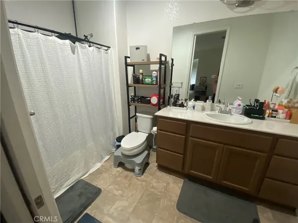 a bathroom with a sink mirror vanity and toilet