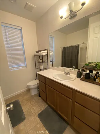 a bathroom with a sink double vanity granite and a mirror