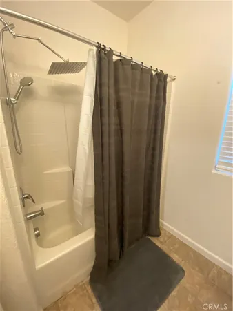 a bathroom with a shower and a tub