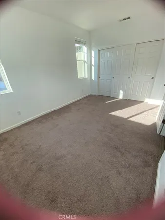 an empty room with a empty space and windows