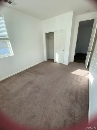 a view of an empty room and a window