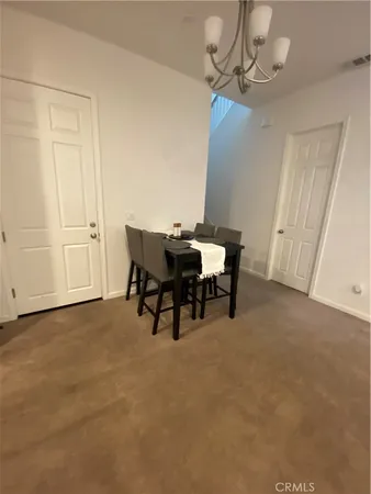 a view of a room with furniture and chandelier