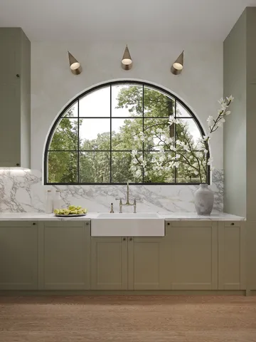 a kitchen with stainless steel appliances granite countertop a sink and a stove
